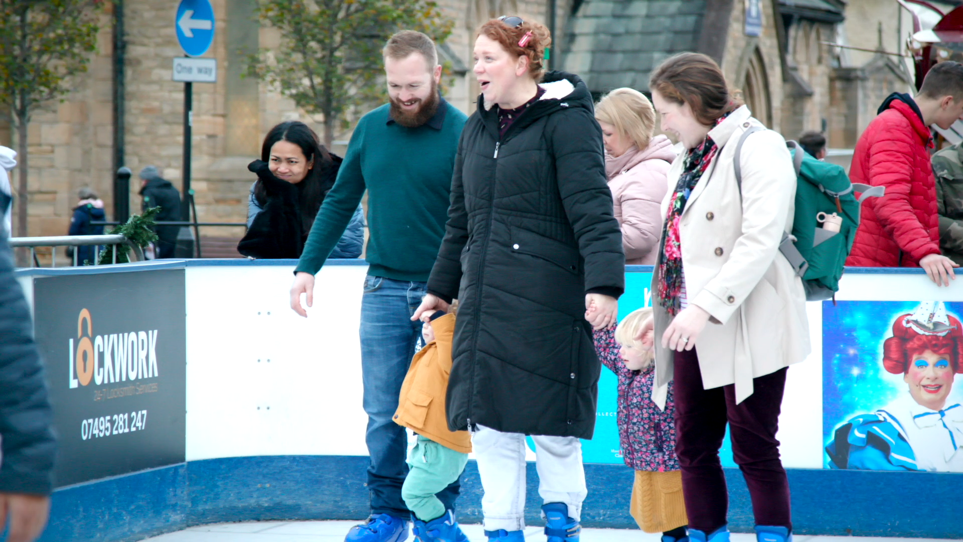 An image of happy people skating in an open air ice skating rink.